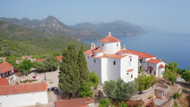 4k drone flight point of view (Ultra High Definition) of Moni Evaggelistrias monastery. Adorable morning scene of Peloponnese peninsula, Greece, Europe. Breathtaking summer seascape of Ionian sea.