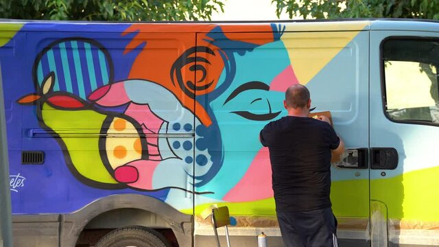international artist day.graffiti artist creating his art in a van