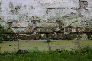 Ancient mossy monastery wall, brickwork, blurred background