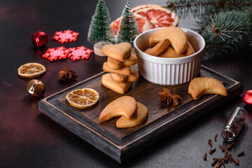 Fototapeta na wymiar Christmas frame with fir tree branches, gingerbread cookies, spices and dried orange rings