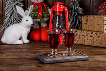 Christmas mulled red wine with spices and fruits on a dark table.