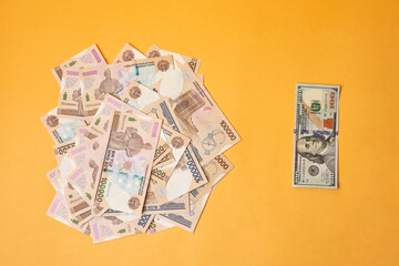 US dollar banknote and Uzbek sums. Concept of exchange rate, Uzbek sum to us dollar. Money exchange...