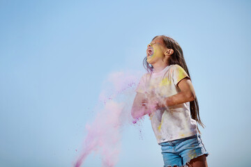 happy little child girl throw bright paints