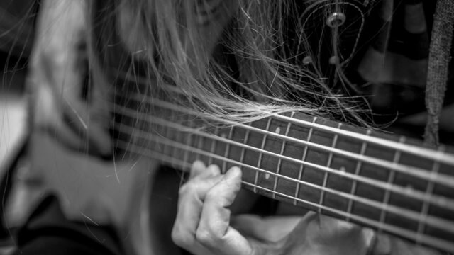 musician playing guitar black and white image, close up