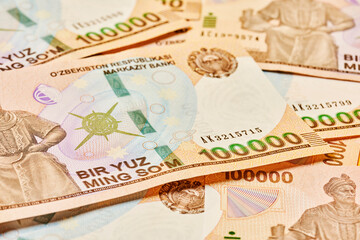 Macro shot of uzbek sum banknote. Pile of Uzbek sums. Uzbek currency money bill. A stack of one hundred thousand Uzbek sum. 100000 sum
