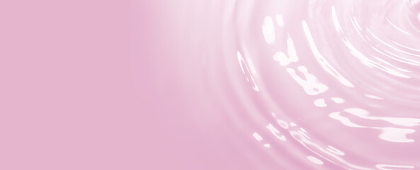 Drops on pink water background under sunlight. Top view, flat lay. Banner Copyspace for text for Cosmetics and Relaxation Concept