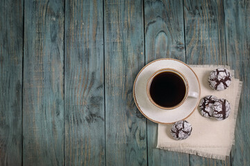 Cup of coffee with cookies on a wooden table, top view, background, copy space, breakfast.

