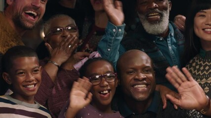african american family posing for photo with friends at christmas dinner party waving enjoying festive holiday reunion celebrating at home 4k