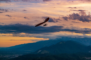 Hang glider in the sunset sky.