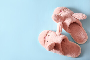 women's slippers and towels on a blue background