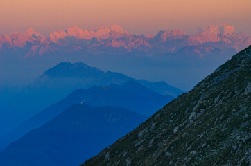 Pink Dolomites mountains illuminated by the first rays of morning sun.