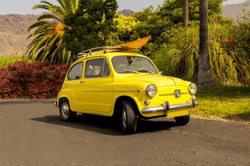 Fototapeten Yellow vintage car.  SEAT 600 1969 Surfing ride © MO PHOTO