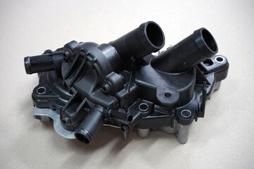 The water pump is part of the engine cooling system of a modern car. Selected focus.
