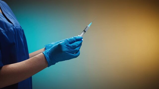 Doctor opening syringe with solution. Nurse wearing protective white gloves showing sample of medicine, vaccination against covid-19, laboratory research concept. Coronavirus vaccine.