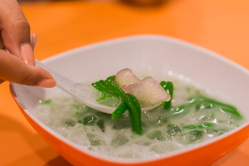 people scooping food from a cup