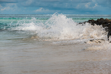 Natural background. Waves and splashes of ocean water on the beach.