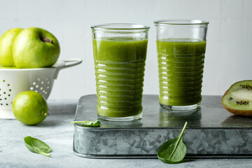 Green vegan smoothie with ginger and spinach in glass.  Clean eating, detox, dieting, vegetarian, vegan,  healthy weight loss food concept