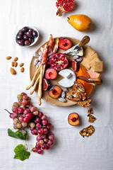 Appetizers table with italian antipasti snacks or authentic traditional spanish tapas set. Fall fruit, cheese and meat variety board. Top view, flat lay