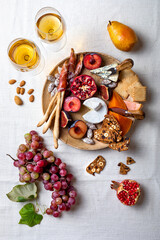 Appetizers table with italian antipasti snacks or authentic traditional spanish tapas set. Fall fruit, cheese and meat variety board. Top view, flat lay