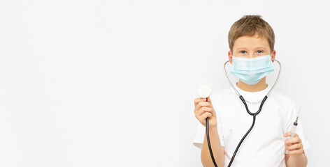 Cute boy doctor wearing medical mask and giving thumbs up isolated on light blue background