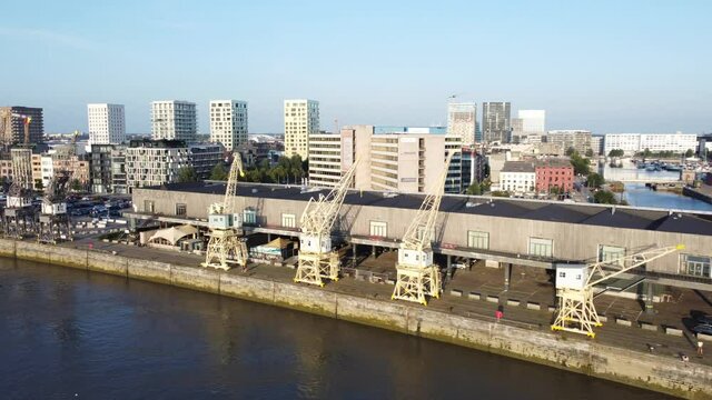 Aerial drone video of the historical harbor cranes on the docks in Antwerp in the beautiful evening light