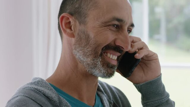mature man using smartphone having phone call chatting enjoying conversation  sharing lifestyle talking on cellphone mobile technology at home 4k