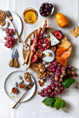 Appetizers table with italian antipasti snacks or authentic traditional spanish tapas set. Fall fruit, cheese and meat variety board. Top view, flat lay