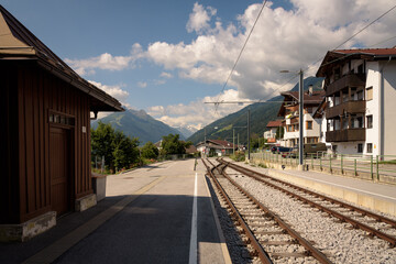 Fototapeta na wymiar Train station with the train tracks towards the mountains, Telfes Im Stubai, Tyrol, Austria
