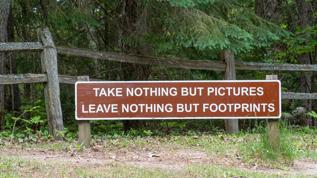 Take Nothing But Photographs, Leave Nothing But Footprints Sign at Tahquamenon Falls State Park, Michigan. Levae No Trace.