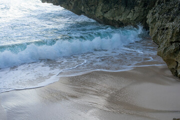 Sea waves between the rocks on the beach.