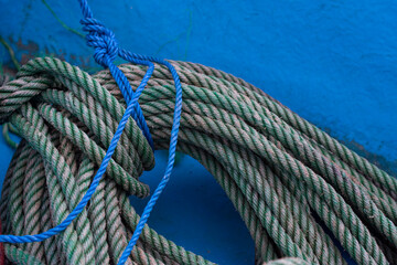 Spool of rope on a blue background.