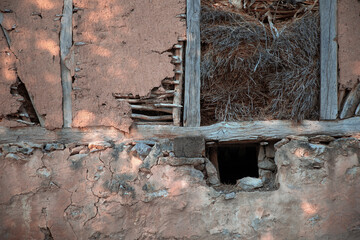 A stable wall build of stone, wood and mud