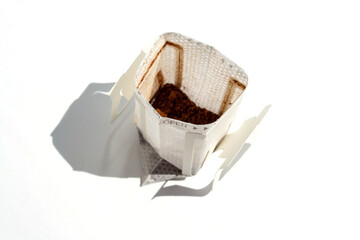 Drip coffee bag isolated on white background with copy space. Opened Instant espresso bag closeup
