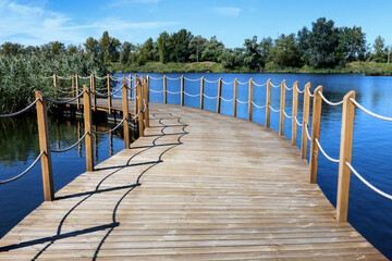 Obraz premium KRAKOW, POLAND - SEPTEMBER 05, 2021: Recreation center by the lake, where wooden jetties float on the water.