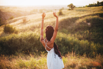 Beautiful black young woman in the park long braids happiness freedom nature