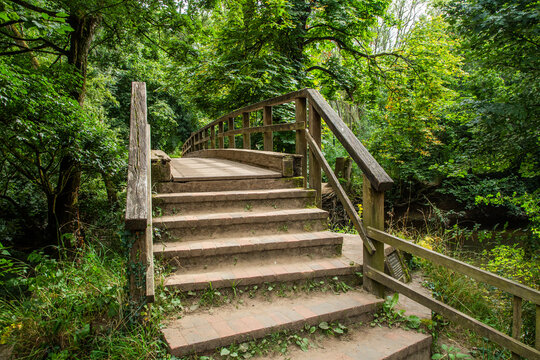 stairs in the forest.  pedestrian bridge on river Mole in Box hill Surrey.