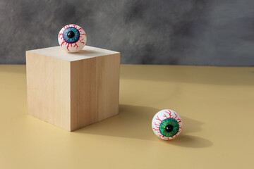Halloween creepy bloody eye lies on the podium. Place for your text. - obrazy, fototapety, plakaty