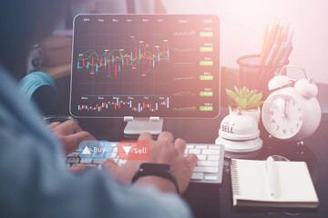 business man is checking daily online stock market prices through a laptop at home with graphs displayed on the screen. Concept of daily business uncle	
