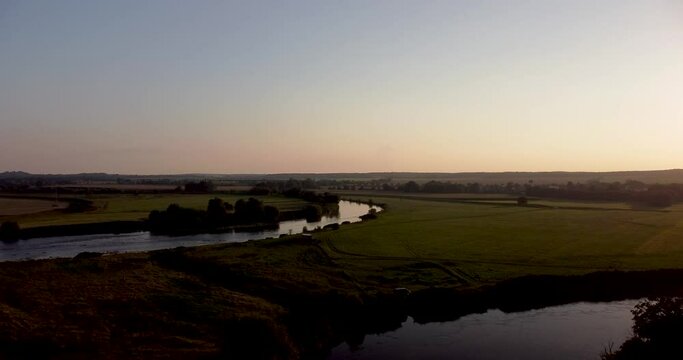 Aerial view of an extensive river landscape in colorful dusk