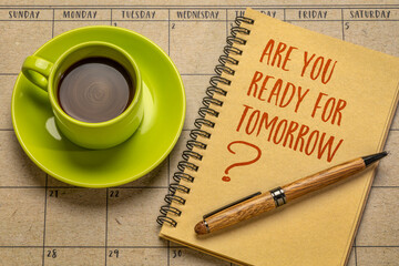 Are you ready for tomorrow question - handwriting on a notebook with a cup of coffee against desktop calendar. Business and personal development concept.