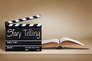 story telling.Text title on film slate and old book on brown background.Education and film industry concept.