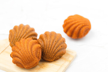 Madeleine cakes with a distinctive shell-like shape on white background for bakery, food and eating concept