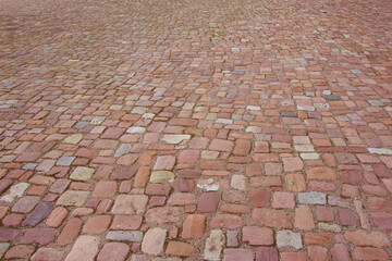 Old cobblestone pavement. Stone paved road in perspective