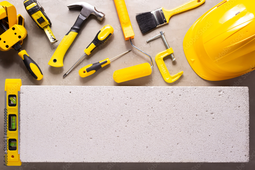 Sticker Aerated concrete  block background. and construction tools. Lightweight concrete