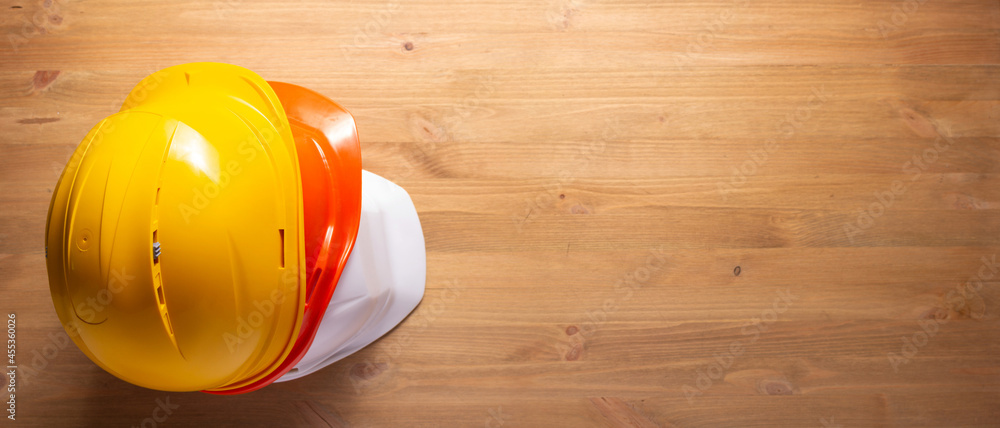 Canvas Prints Construction helmet at wood table background texture. Hardhat on wooden floor