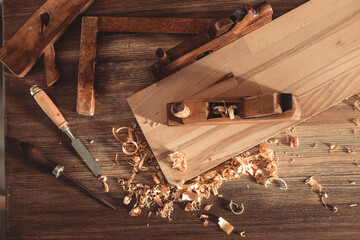 Plane jointer carpenter or joiner tool and wood shavings. Woodworking tools on wooden table - 455360093