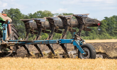 Agricultural tractor plowing a field before sowing