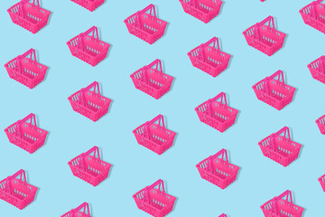Outstanding pattern with pink empty shopping baskets isolated on a blue background