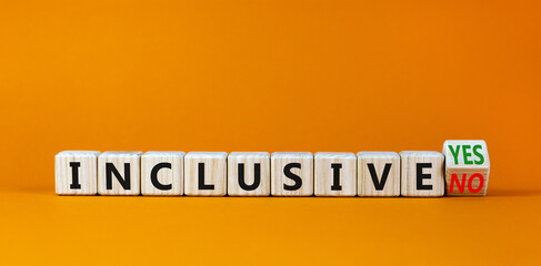Inclusive yes or no symbol. Turned a wooden cube and changed words 'inclusive no' to 'inclusive yes'. Beautiful orange background. Business and inclusive yes or no concept, copy space.