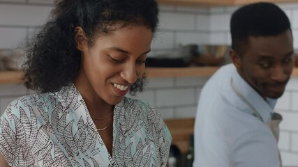 happy young mixed race couple cooking together in kitchen preparing dinner woman chopping vegetables helping boyfriend enjoying healthy lifestyle making food at home 4k - Powered by Adobe